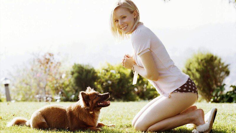Woman with dog in garden