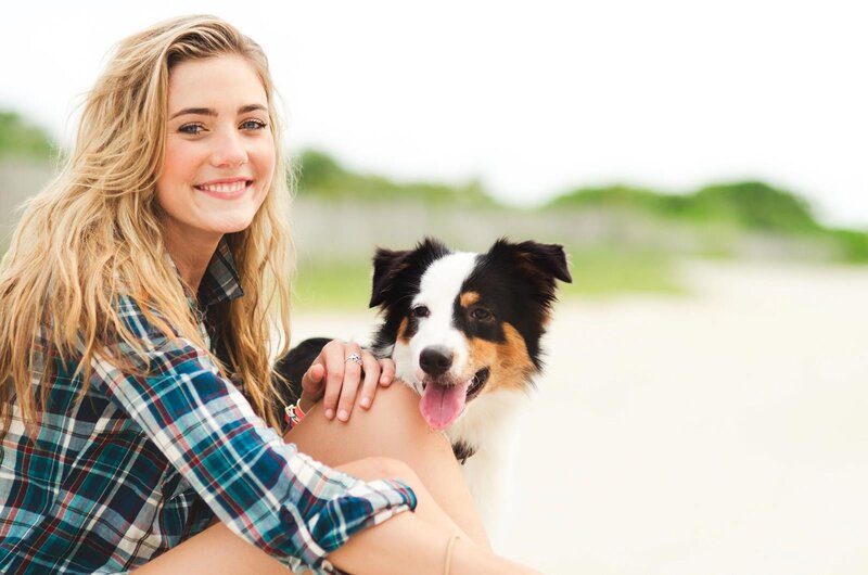 woman with dog on beach