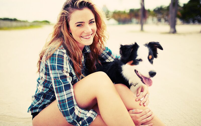 woman with dog on beach