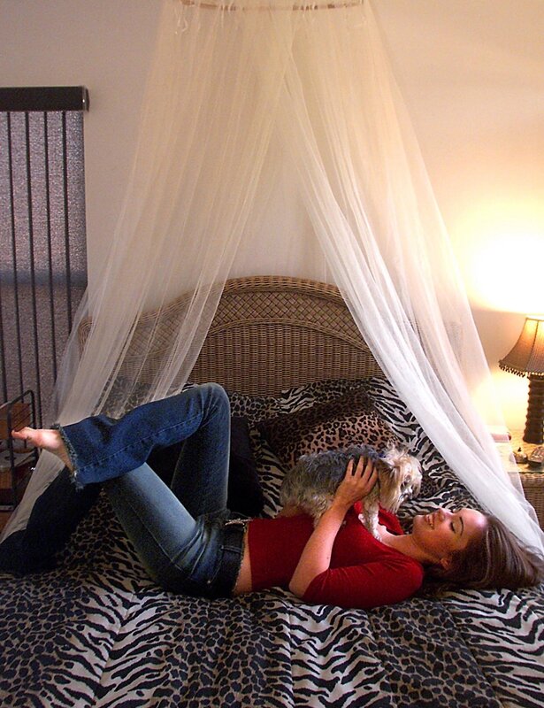 Woman with dog on bed