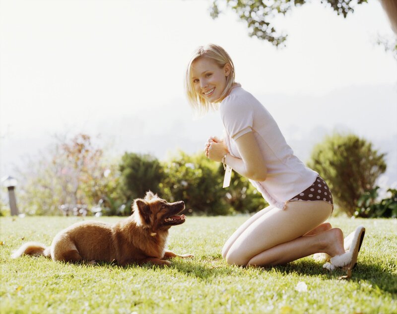 Woman with dog on lawn