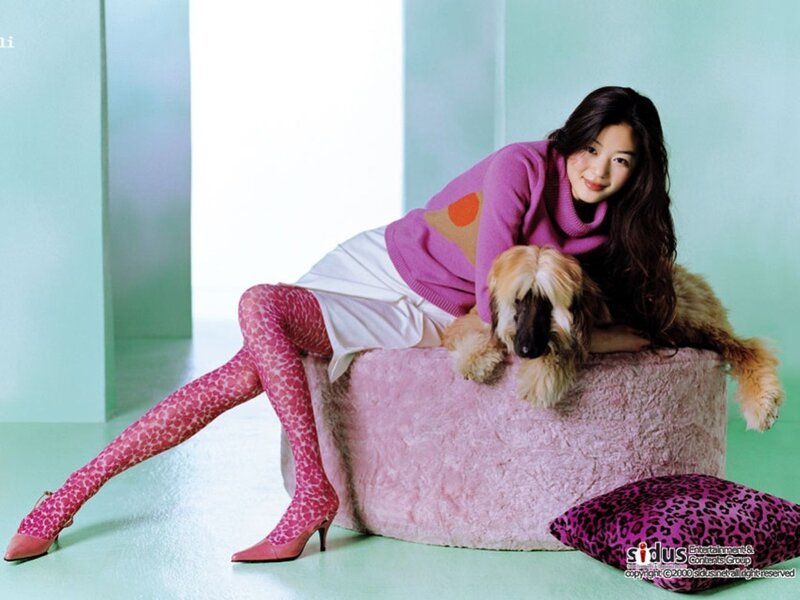 woman with dog on pink couch