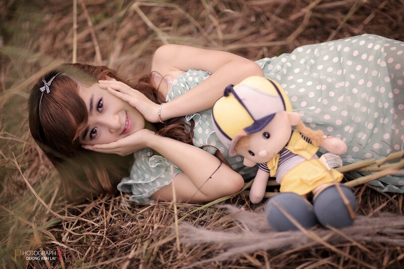 Woman with doll in field