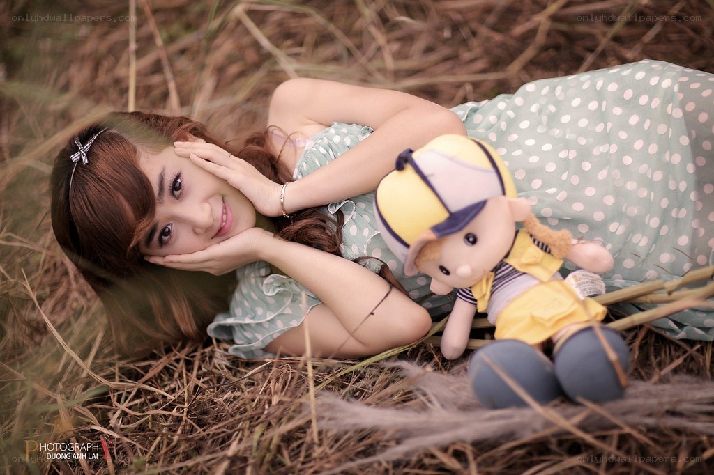 Woman with doll in field