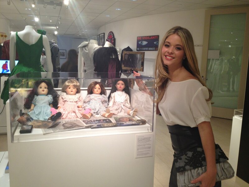 Woman with Dolls in Display