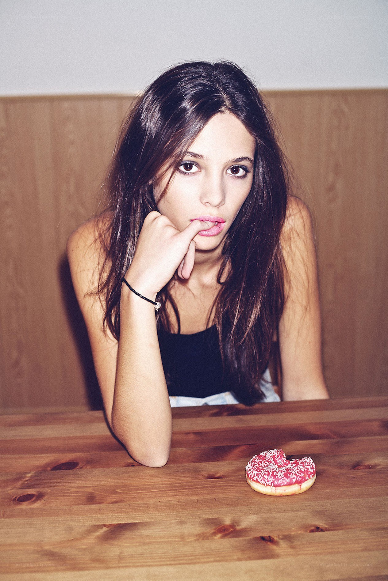 woman with donut on table