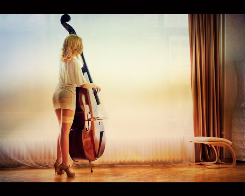 Woman with double bass by window