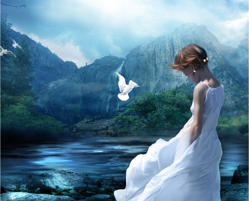Woman with doves in mountain valley