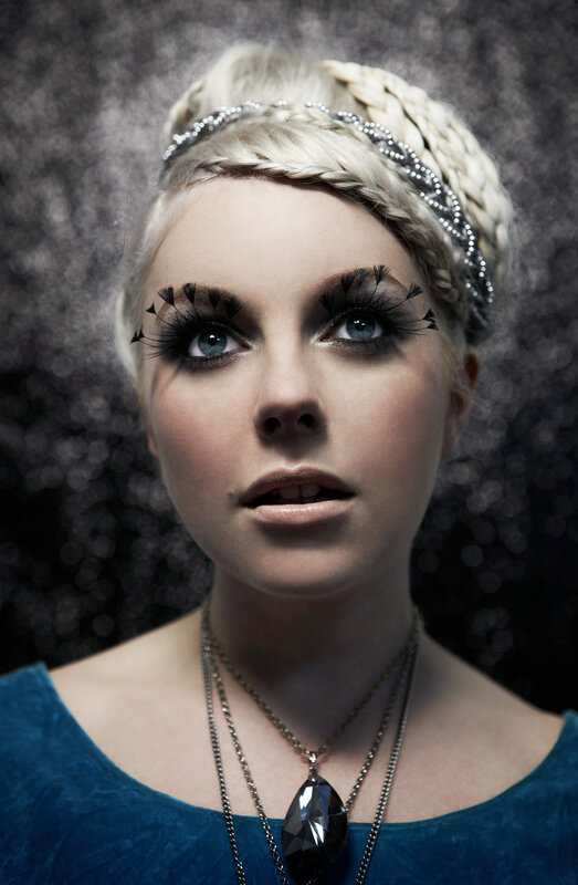 woman with dramatic makeup and braided hair