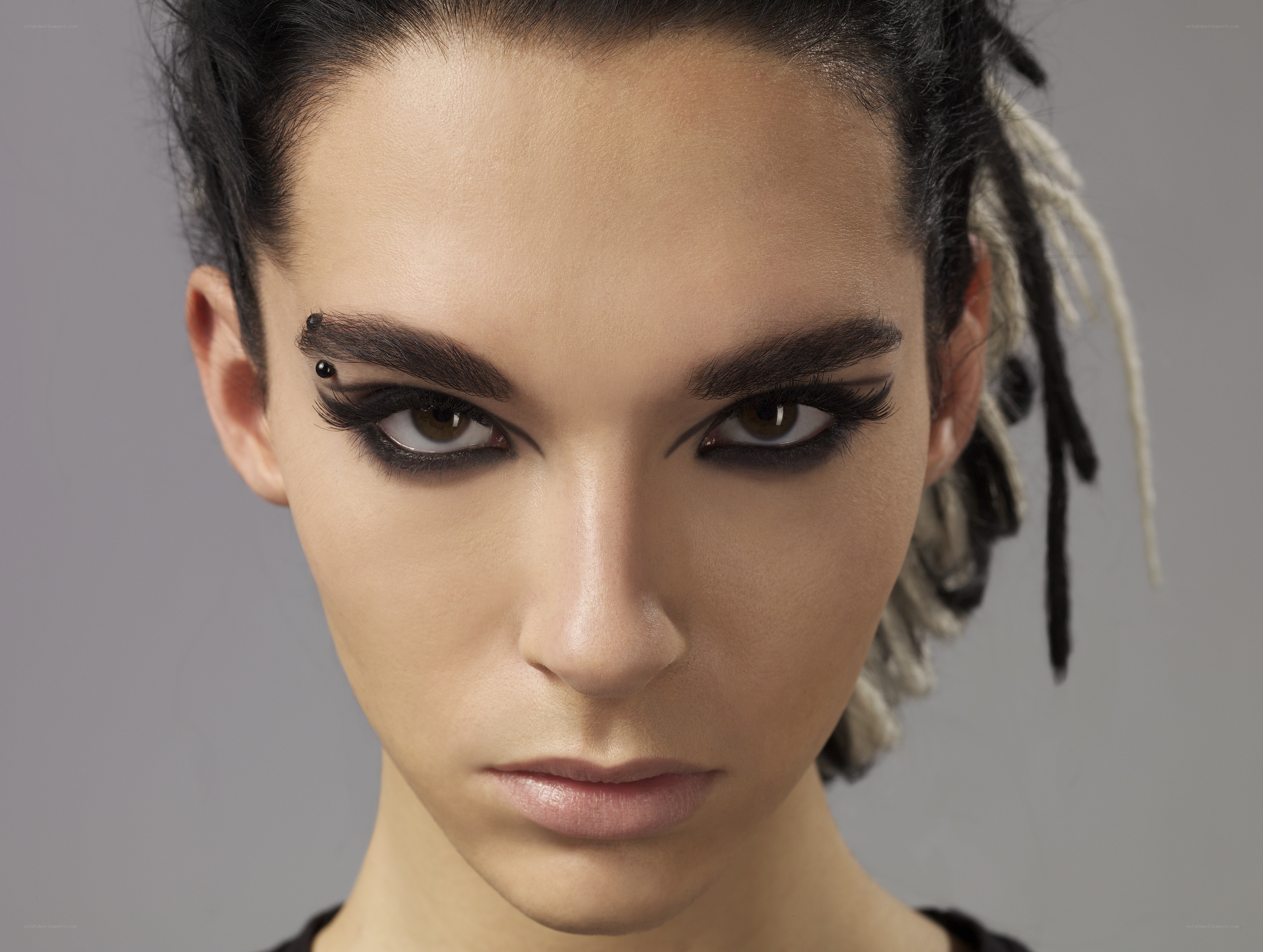 woman with dramatic makeup and dreadlocks