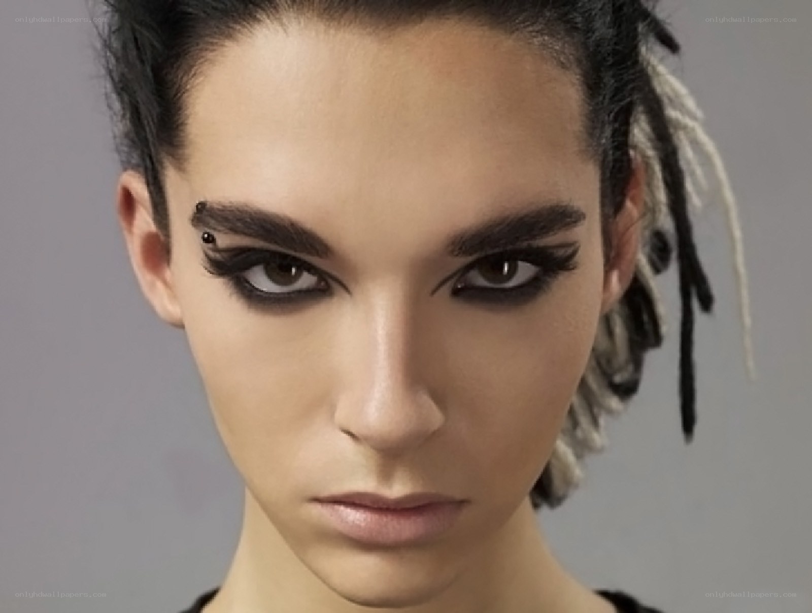 woman with dramatic makeup and dreadlocks