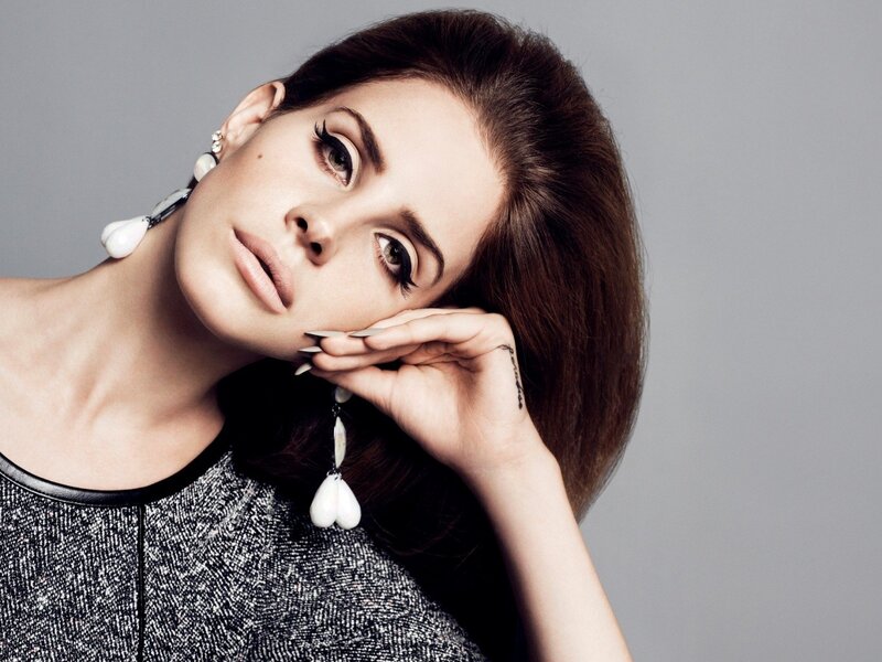 woman with dramatic makeup and earrings