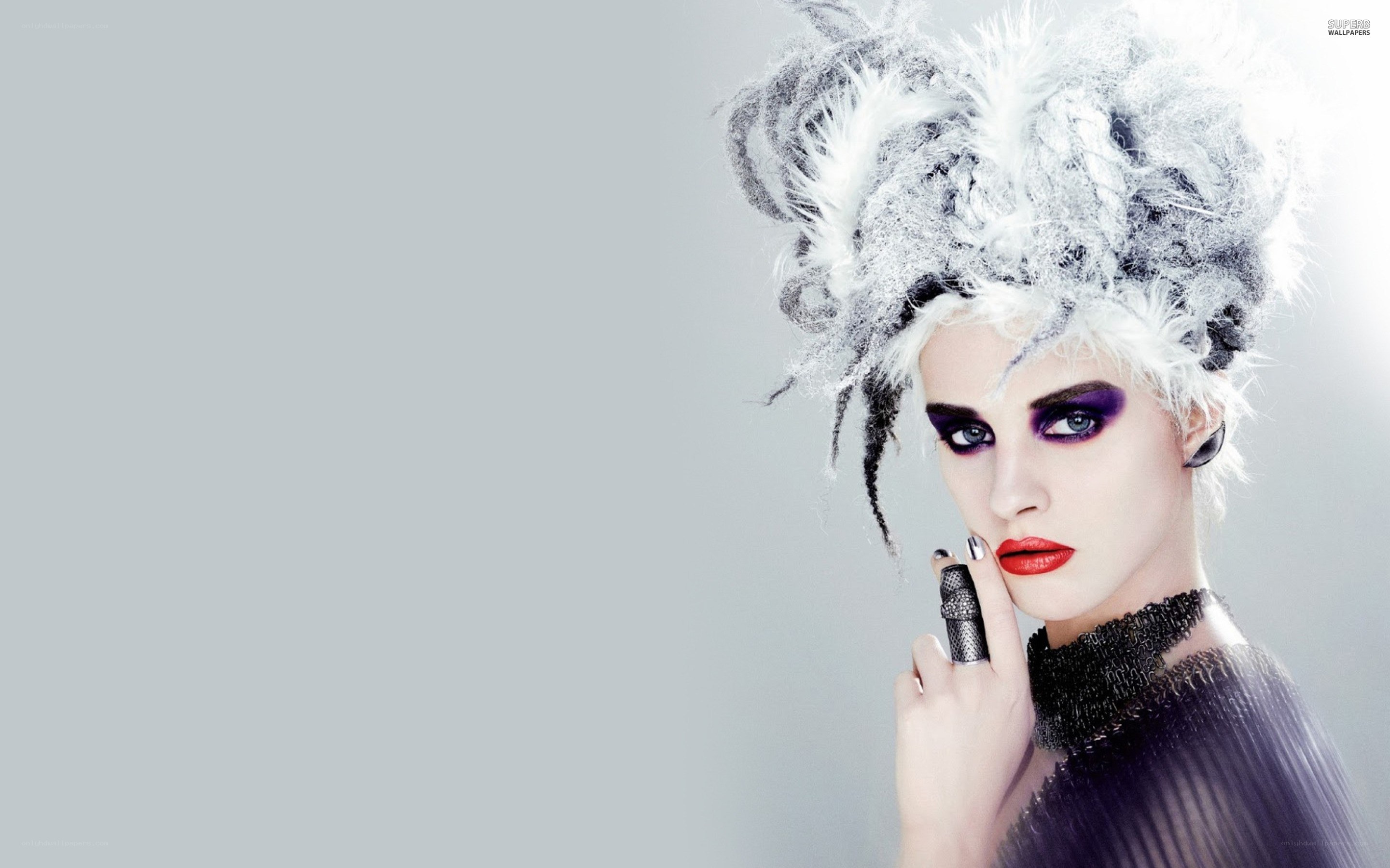 woman with dramatic makeup and feathered hat