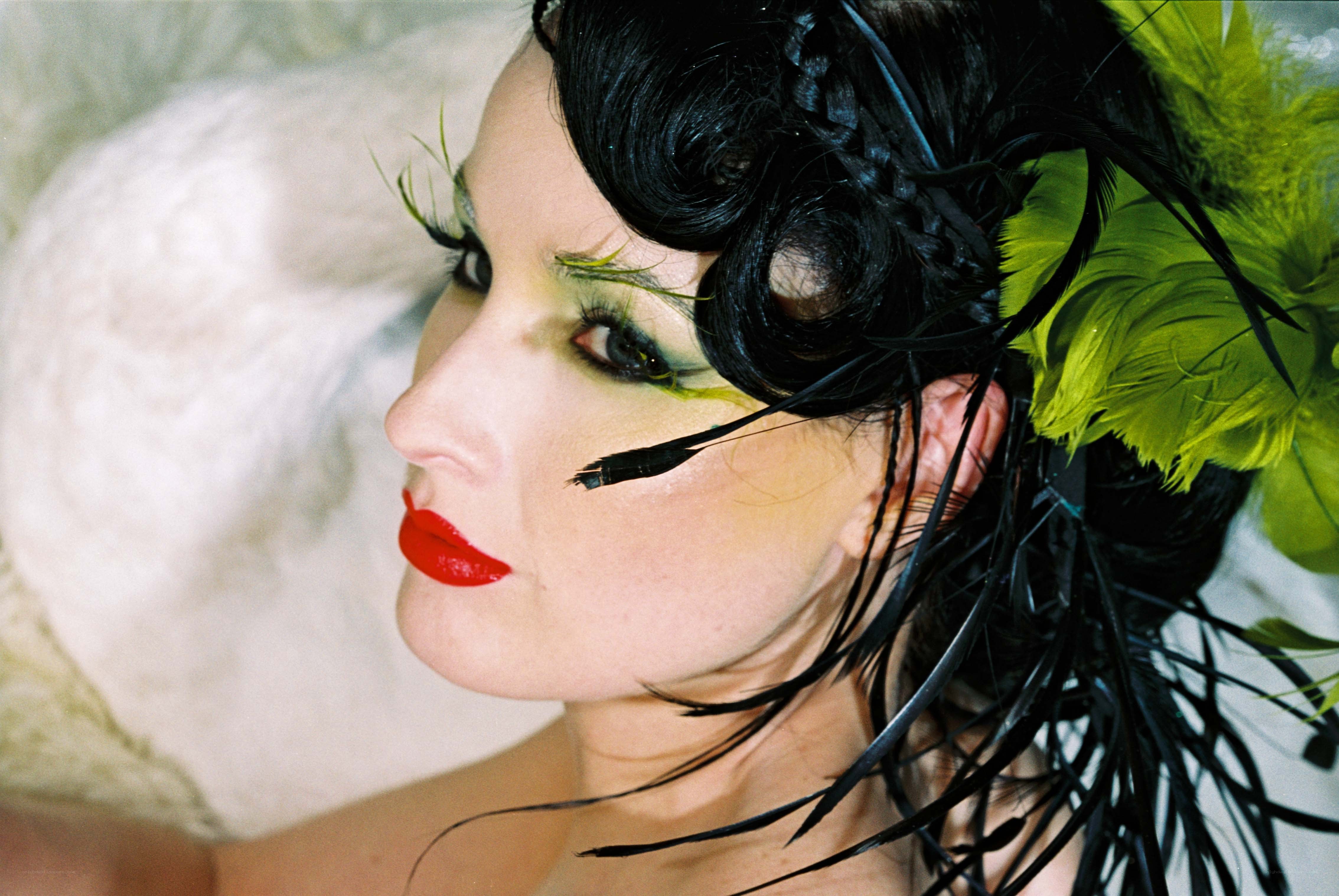 woman with dramatic makeup and feathers