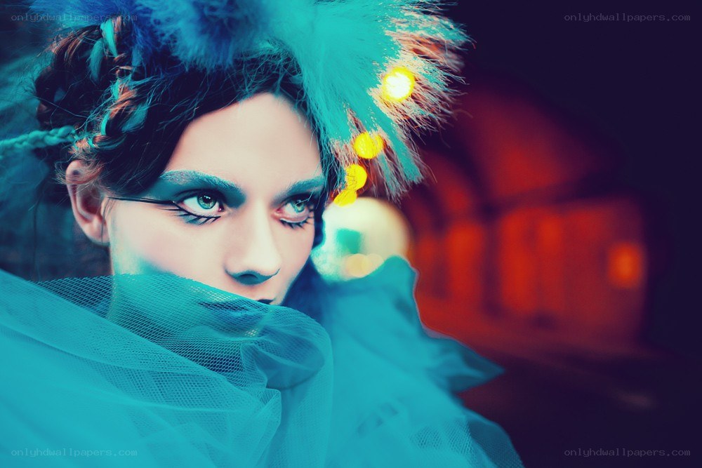 woman with dramatic makeup and feathers