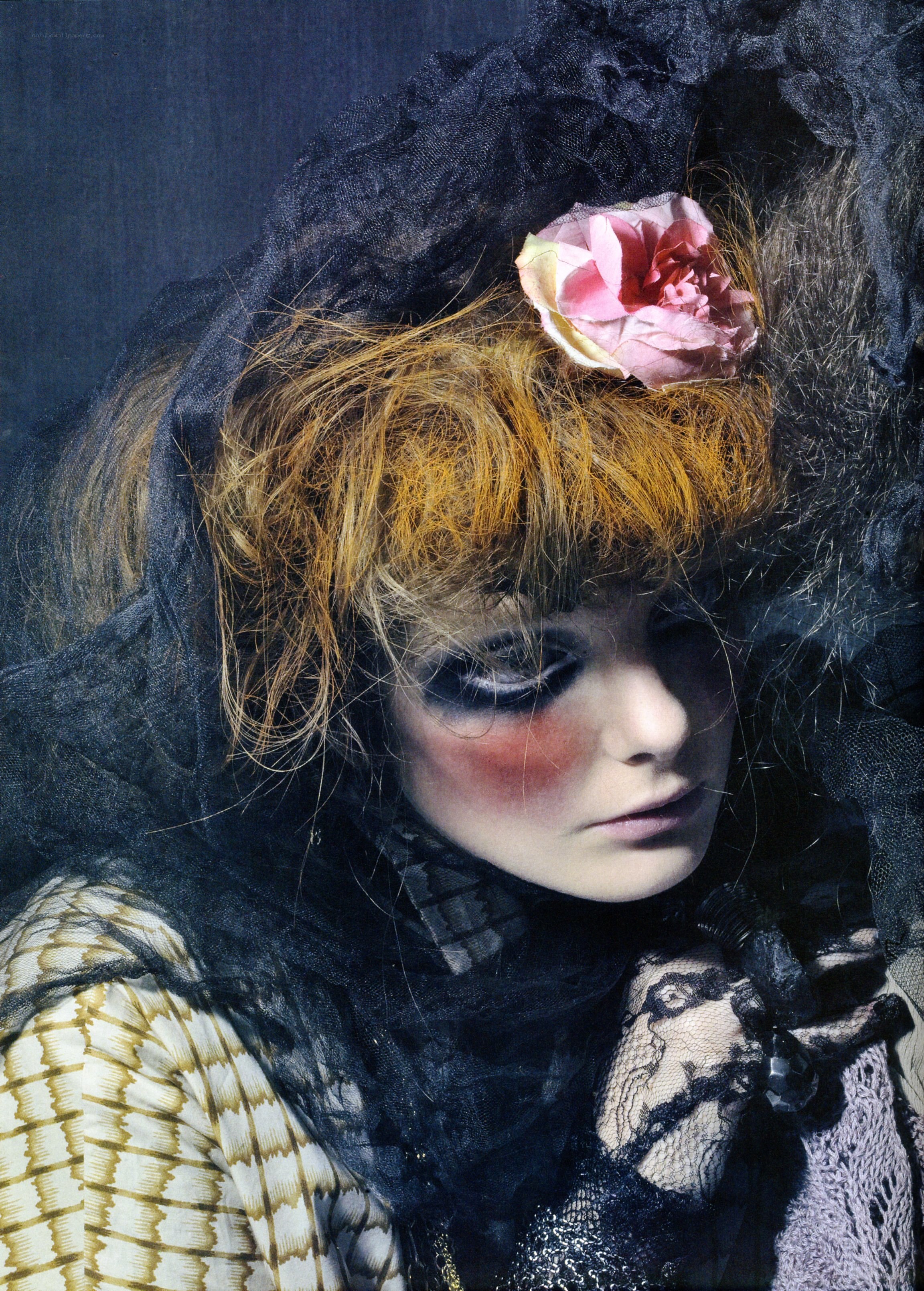 woman with dramatic makeup and flower
