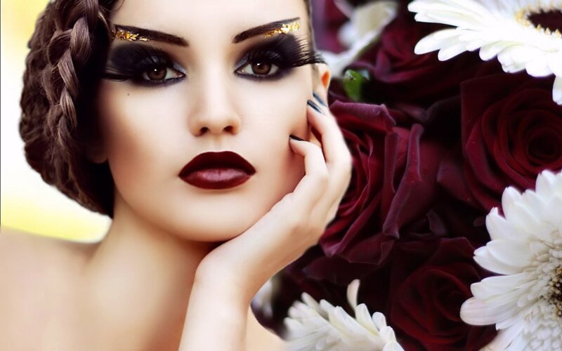 woman with dramatic makeup and flowers