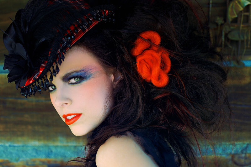 woman with dramatic makeup and hat