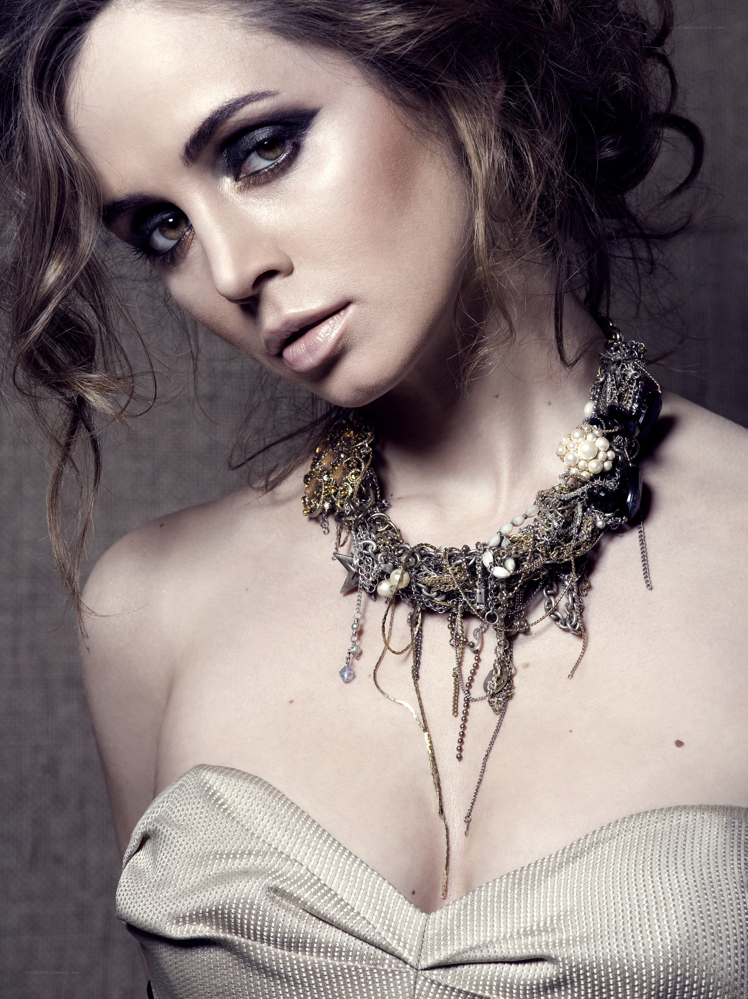 woman with dramatic makeup and necklace