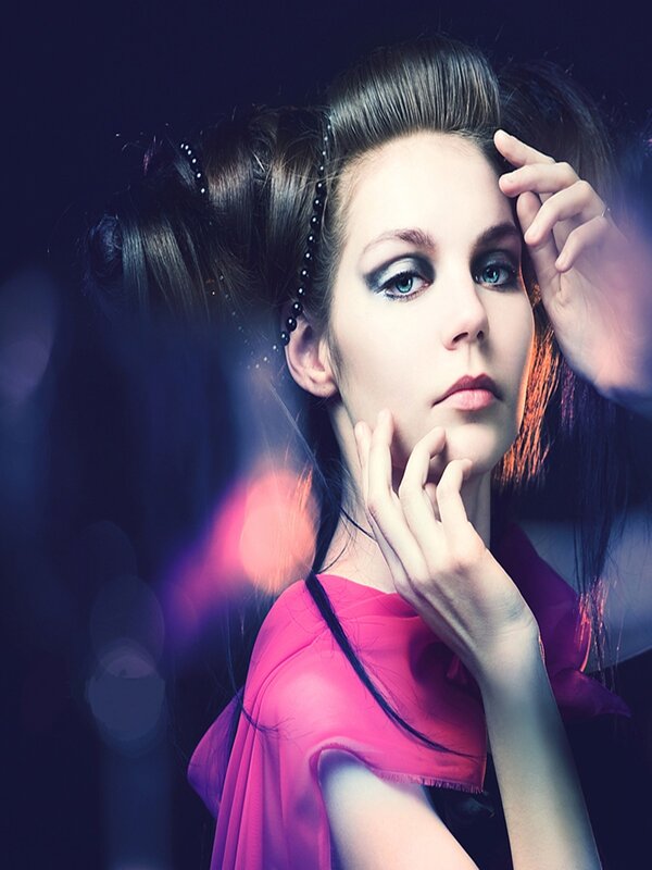 woman with dramatic makeup and pink dress