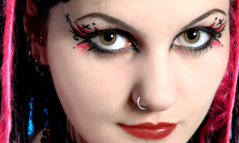 woman with dramatic makeup and pink hair