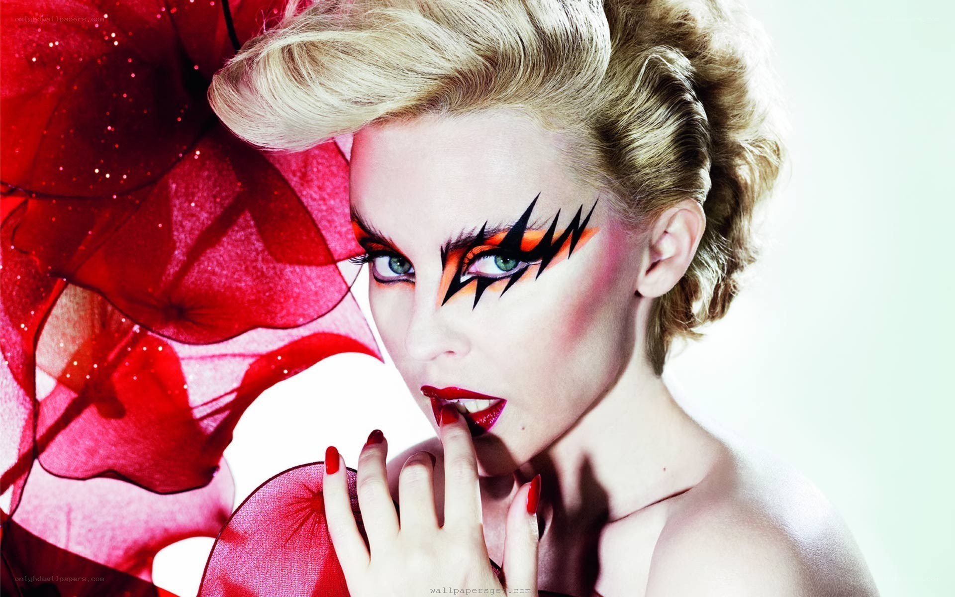 woman with dramatic makeup and red fabric