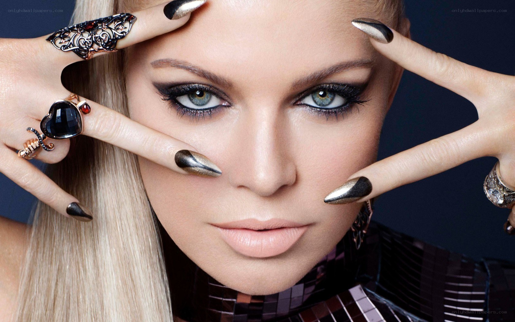 woman with dramatic makeup and rings