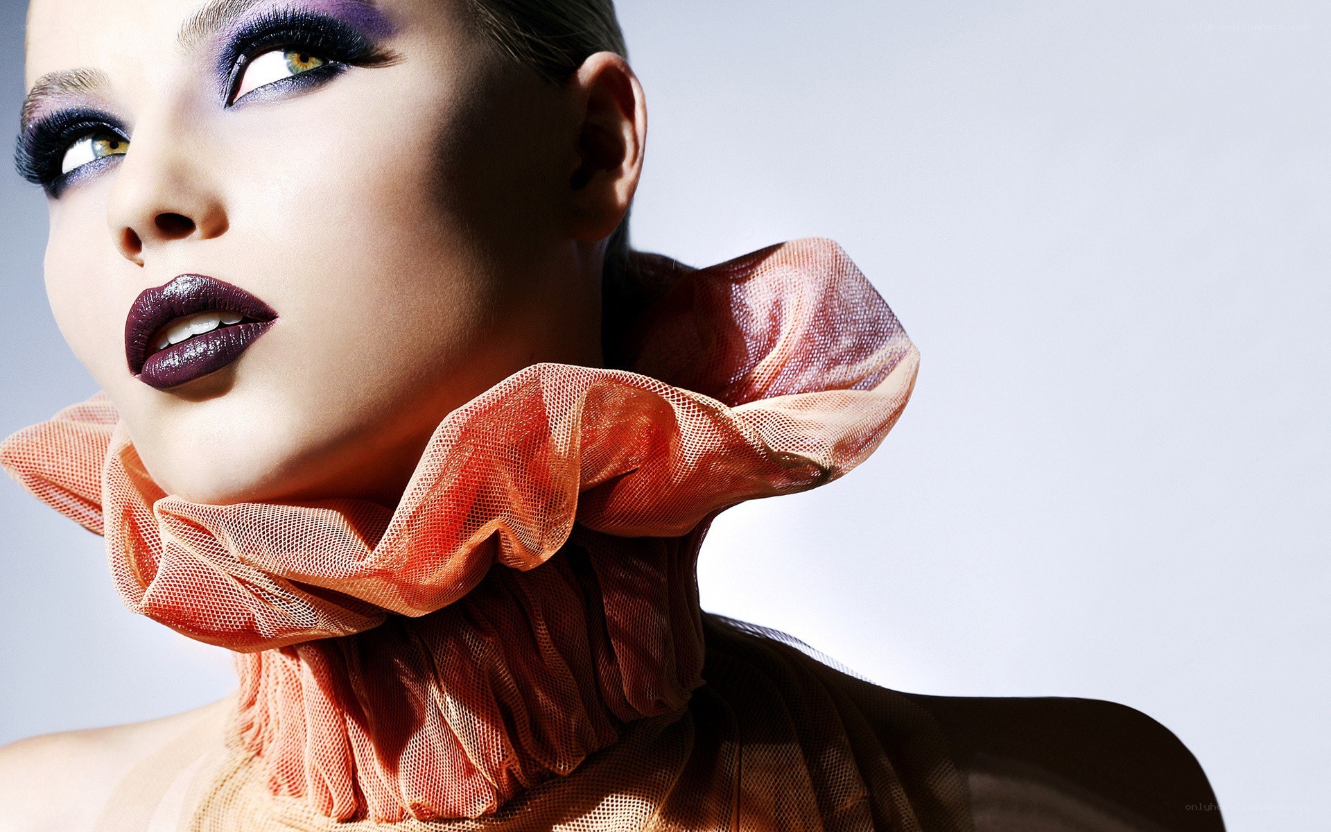 woman with dramatic makeup and ruffled collar