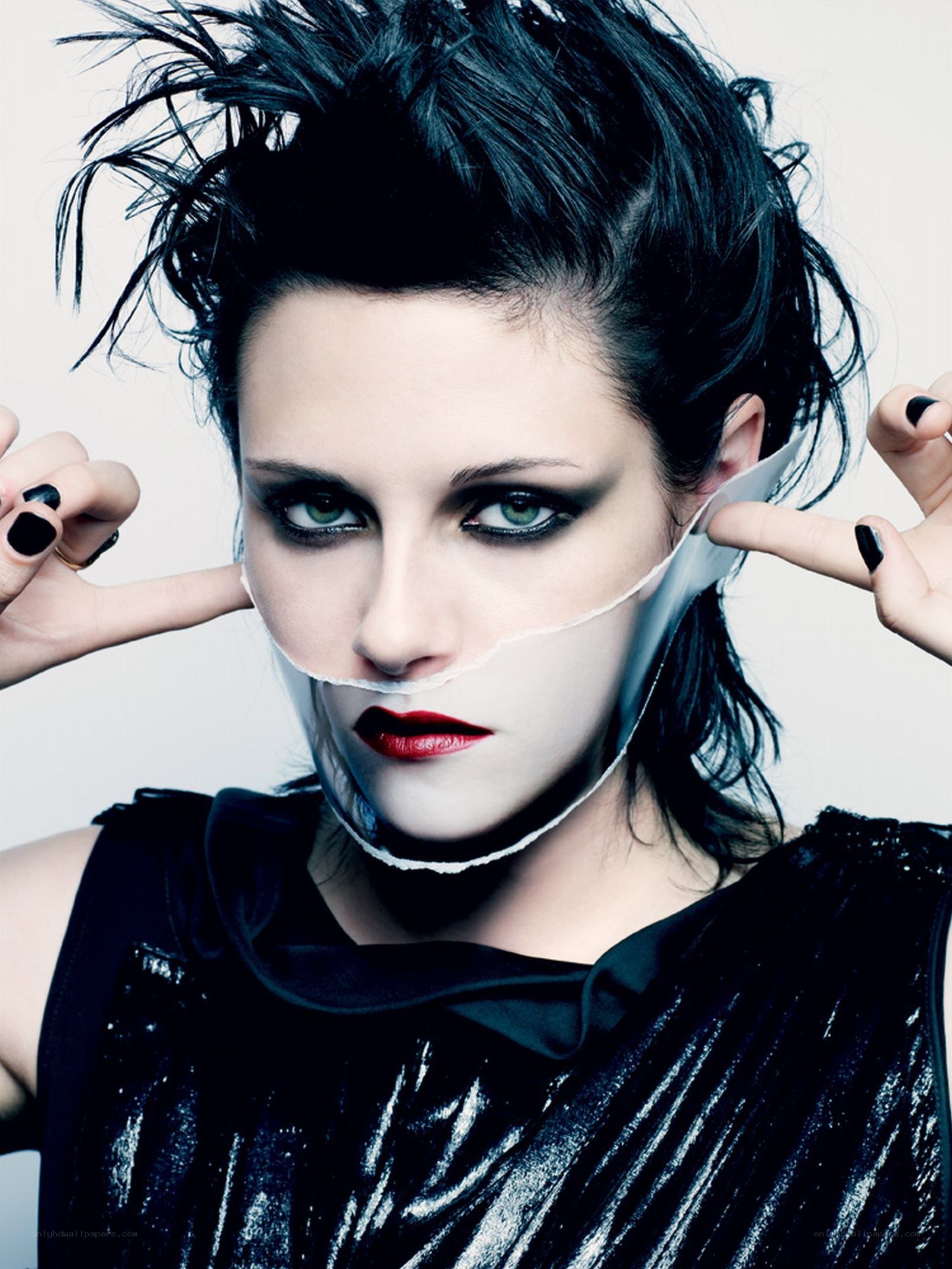 woman with dramatic makeup and torn mask