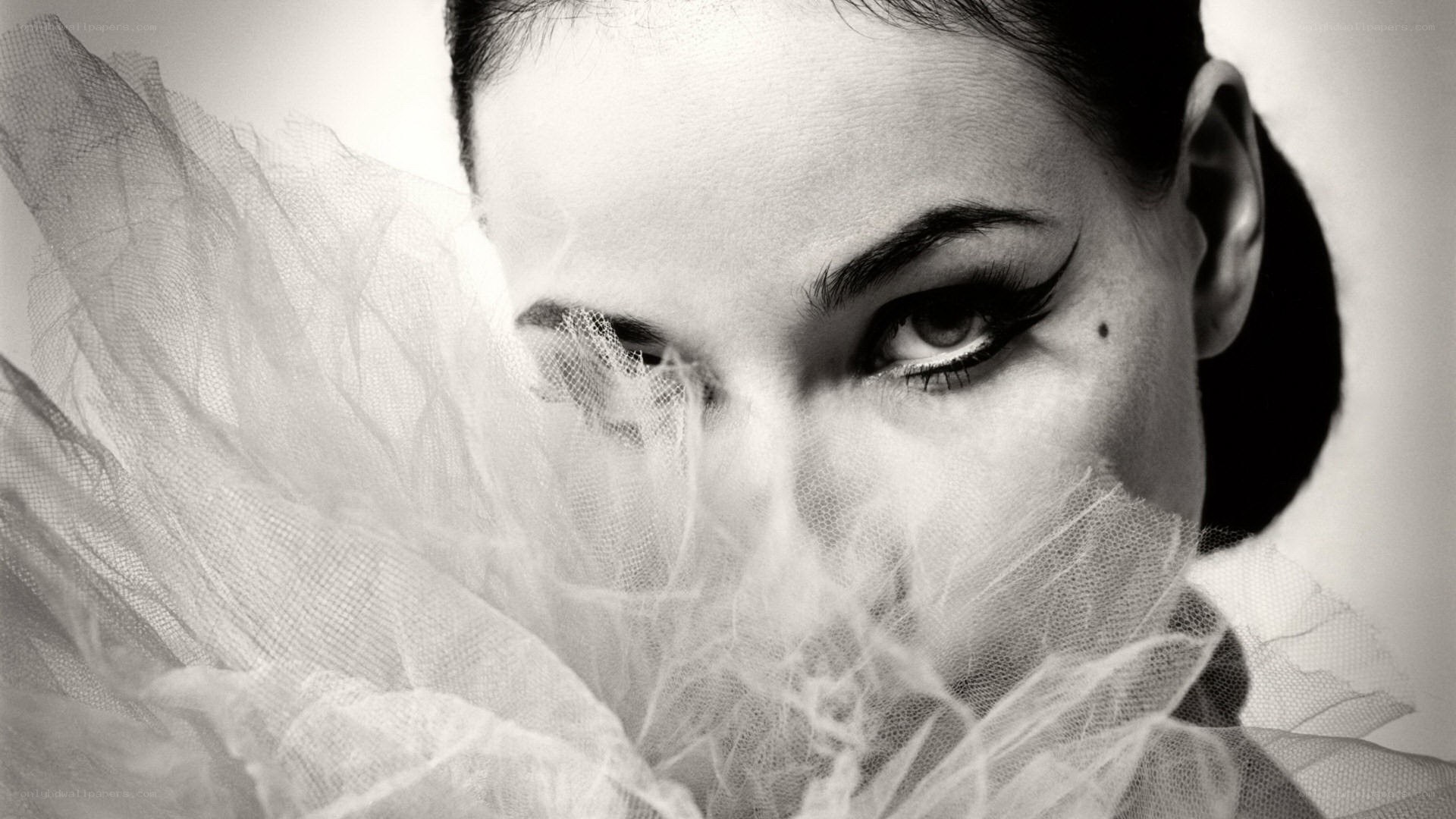 woman with dramatic makeup and tulle
