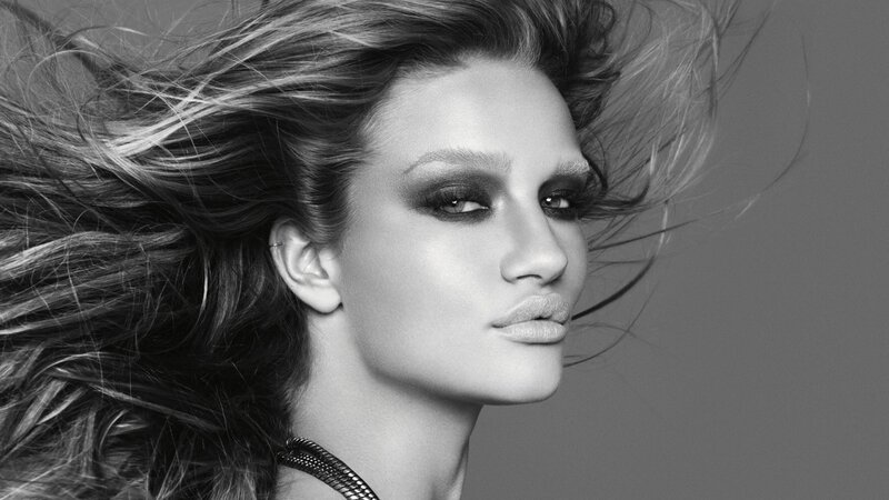 woman with dramatic makeup and wind-swept hair