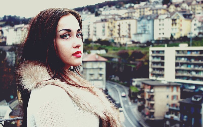 woman with dramatic makeup in city