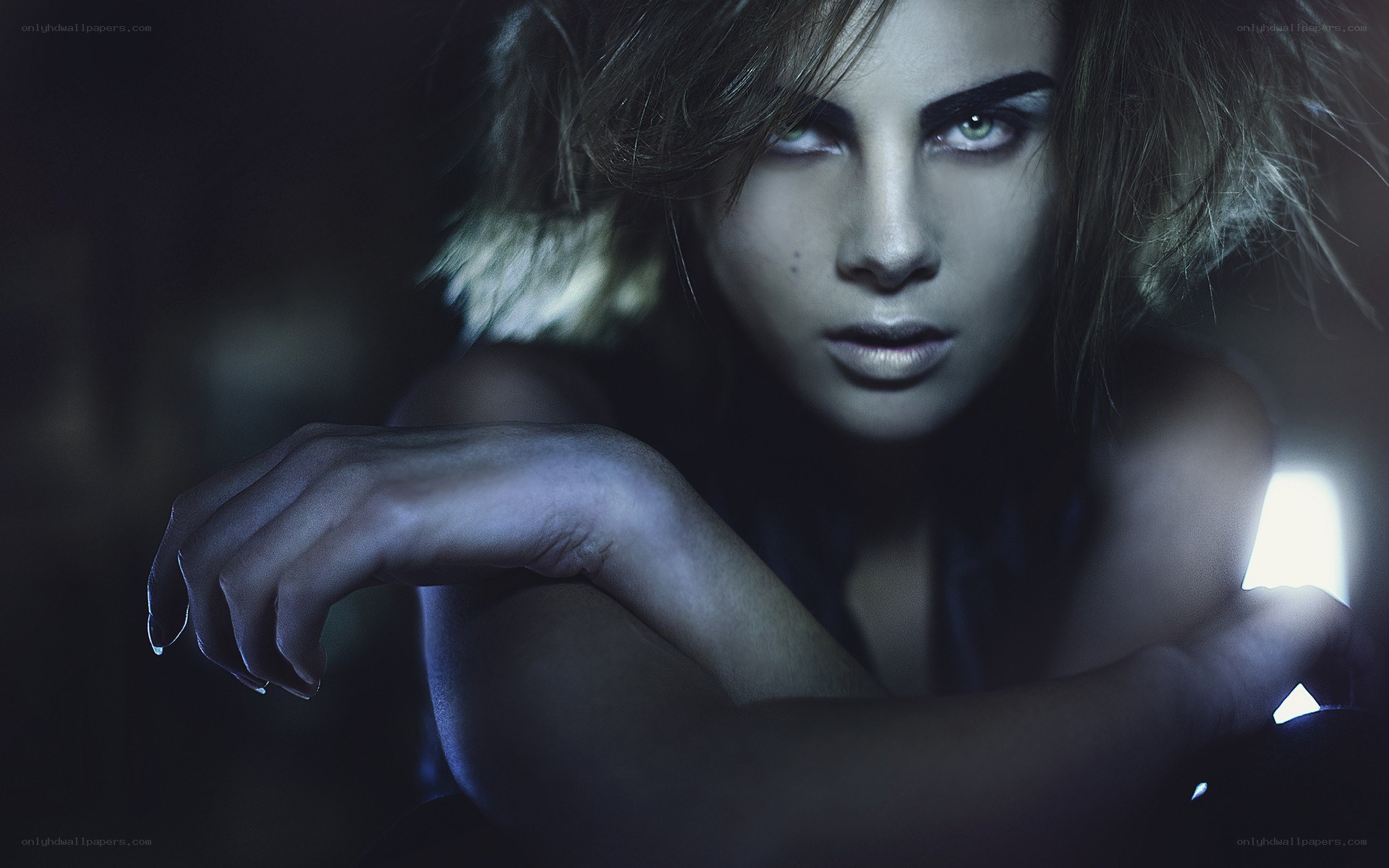 woman with dramatic makeup in dark setting
