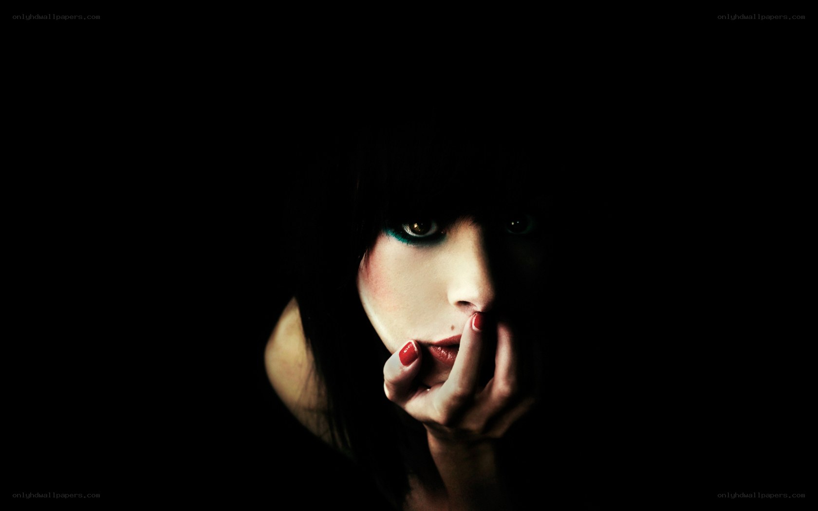 woman with dramatic makeup in darkness