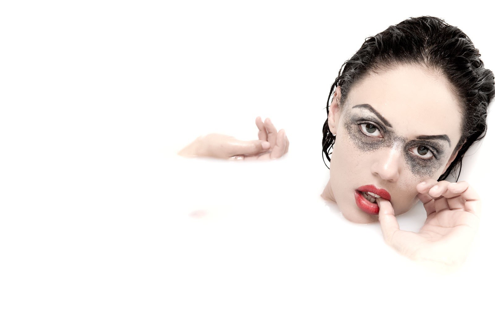 woman with dramatic makeup in water
