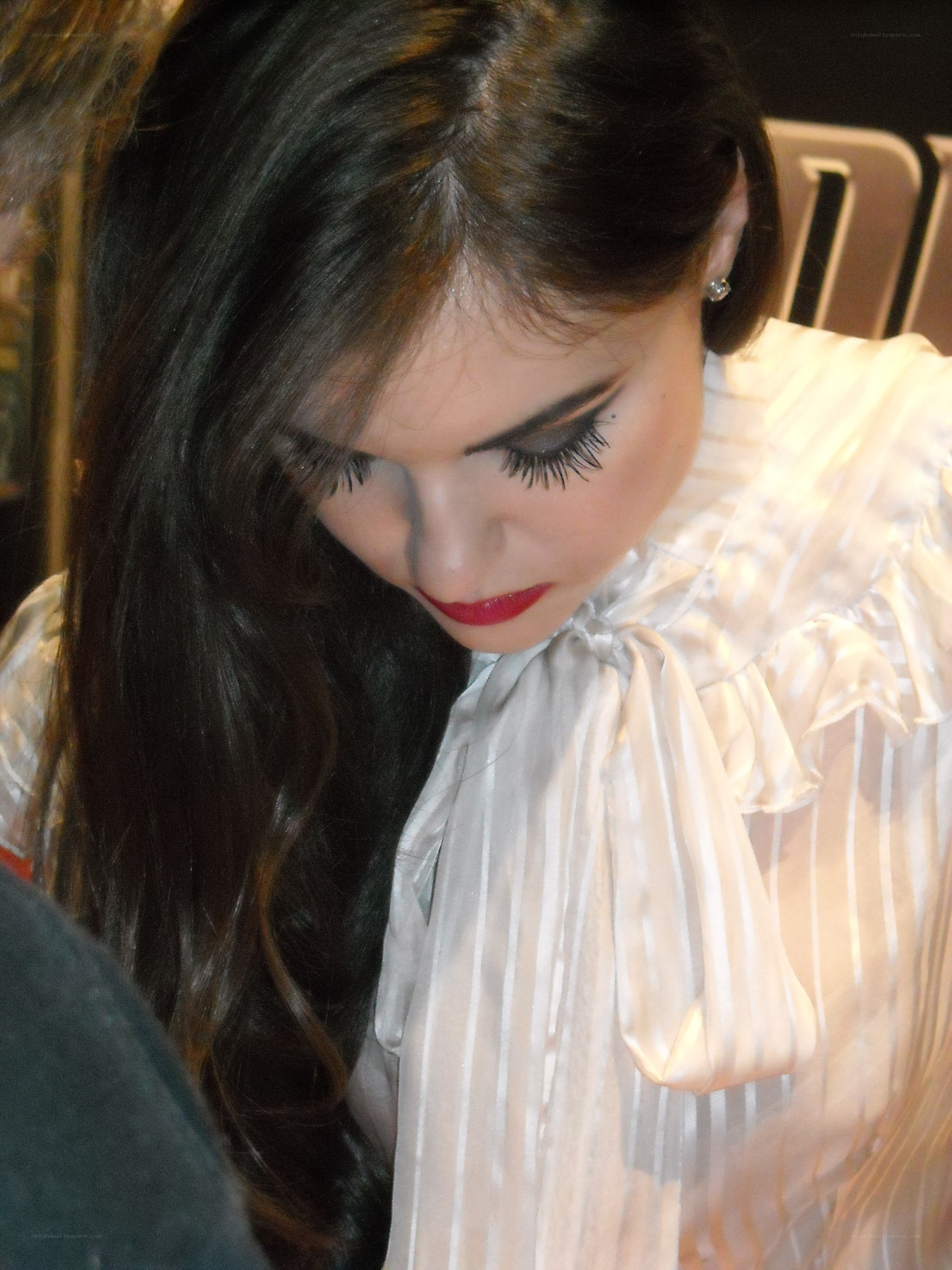 woman with dramatic makeup looking down