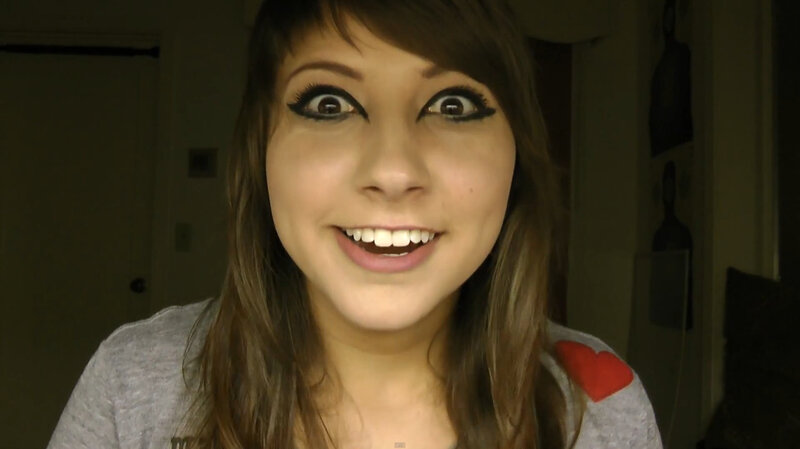 woman with dramatic makeup smiling