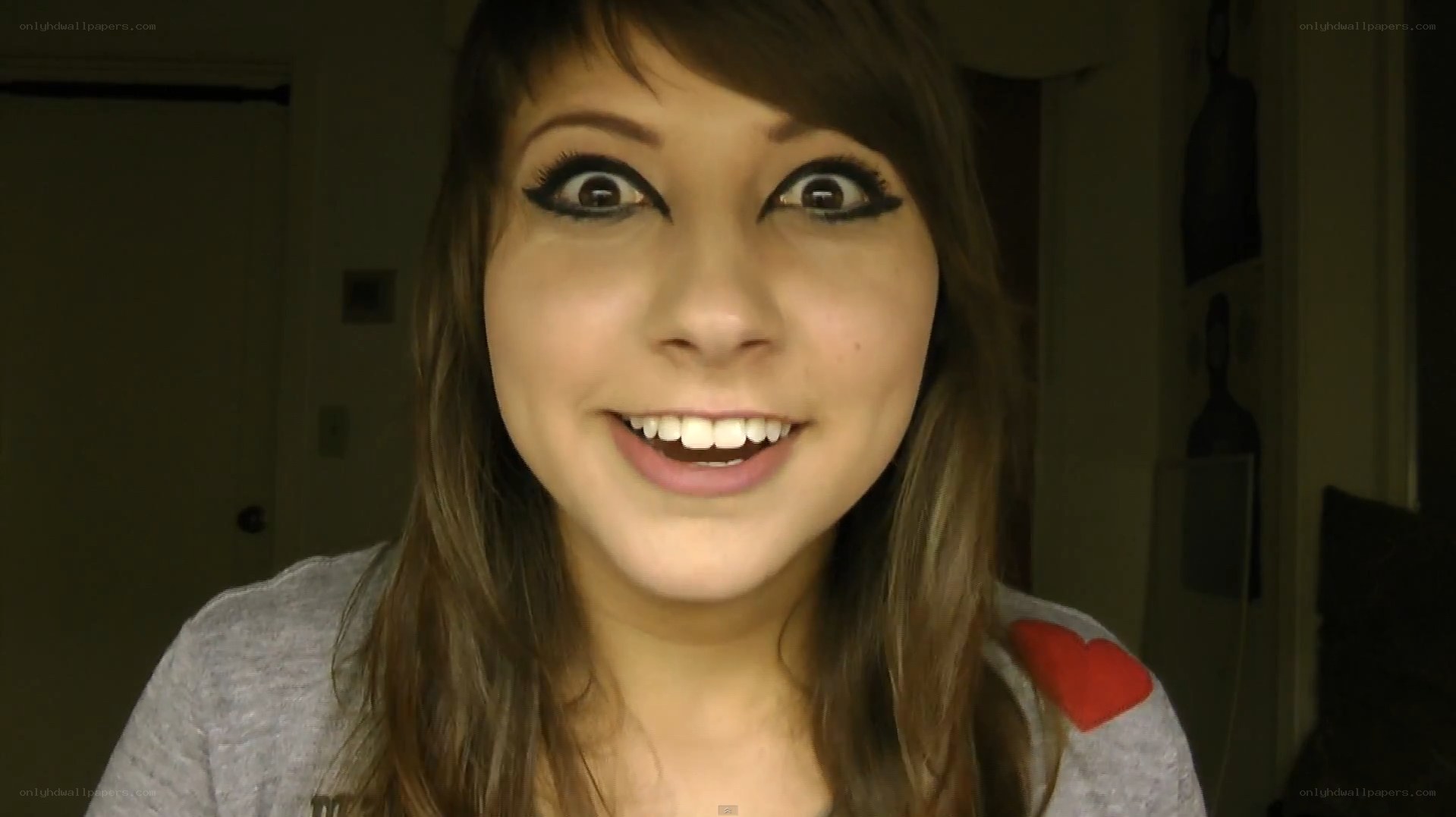 woman with dramatic makeup smiling