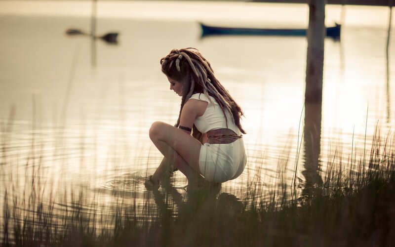 woman with dreadlocks by the water