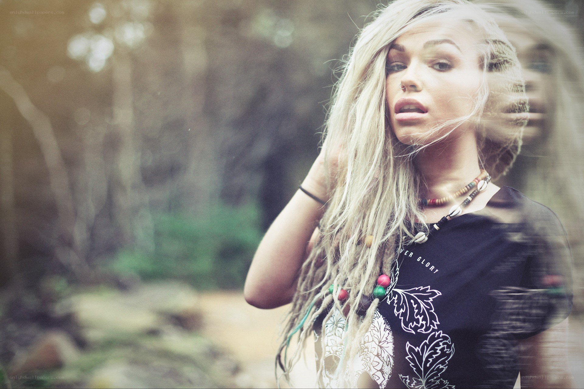woman with dreadlocks in forest