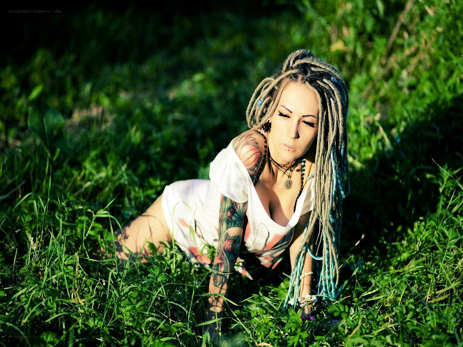 woman with dreadlocks in grass