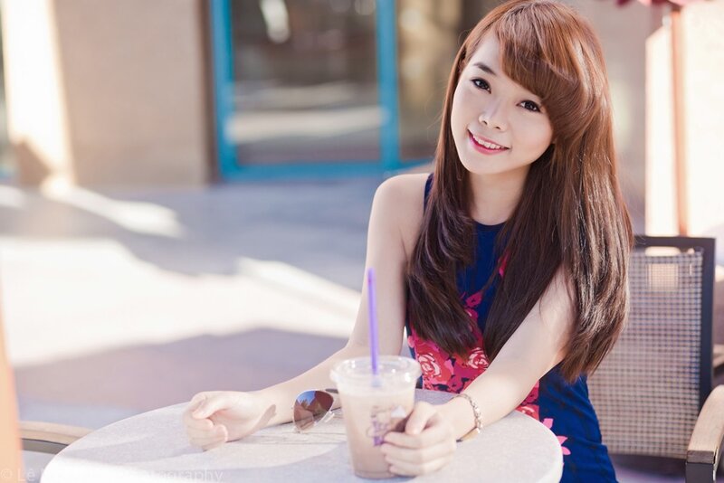woman with drink at outdoor table