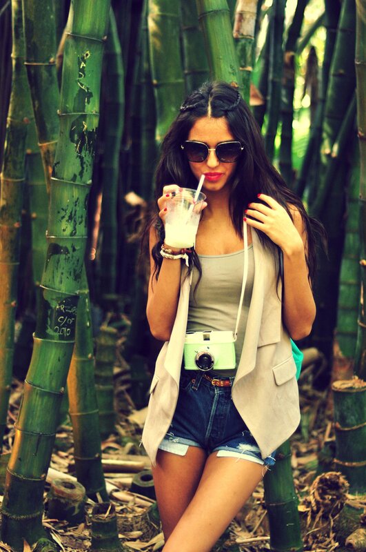 Woman with drink in bamboo forest