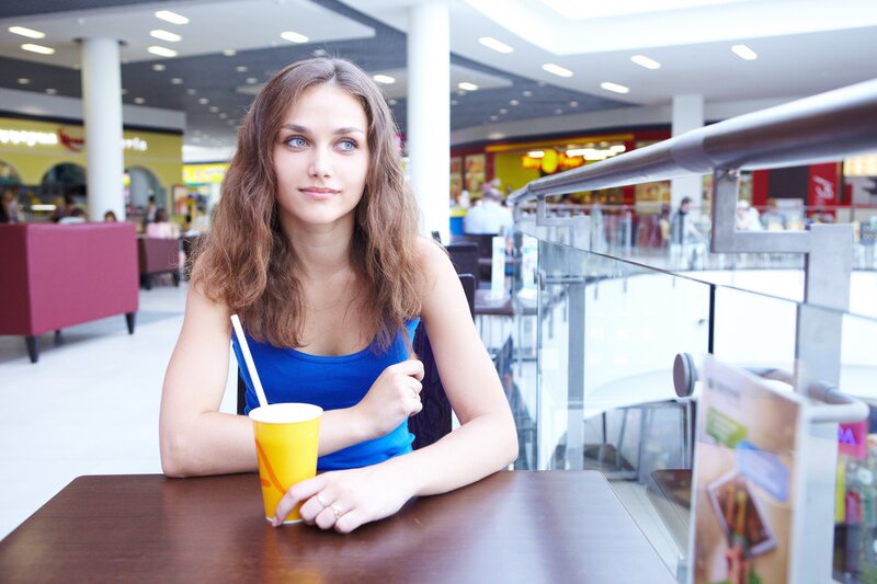 Woman with drink in mall