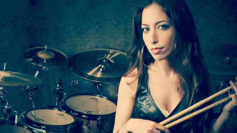 woman with drumsticks and drums