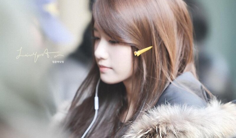 woman with earphones and hair clip