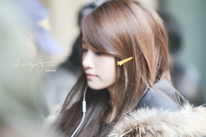 woman with earphones and hair clip