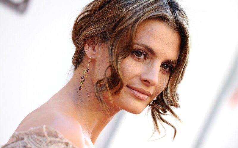 woman with earrings smiling