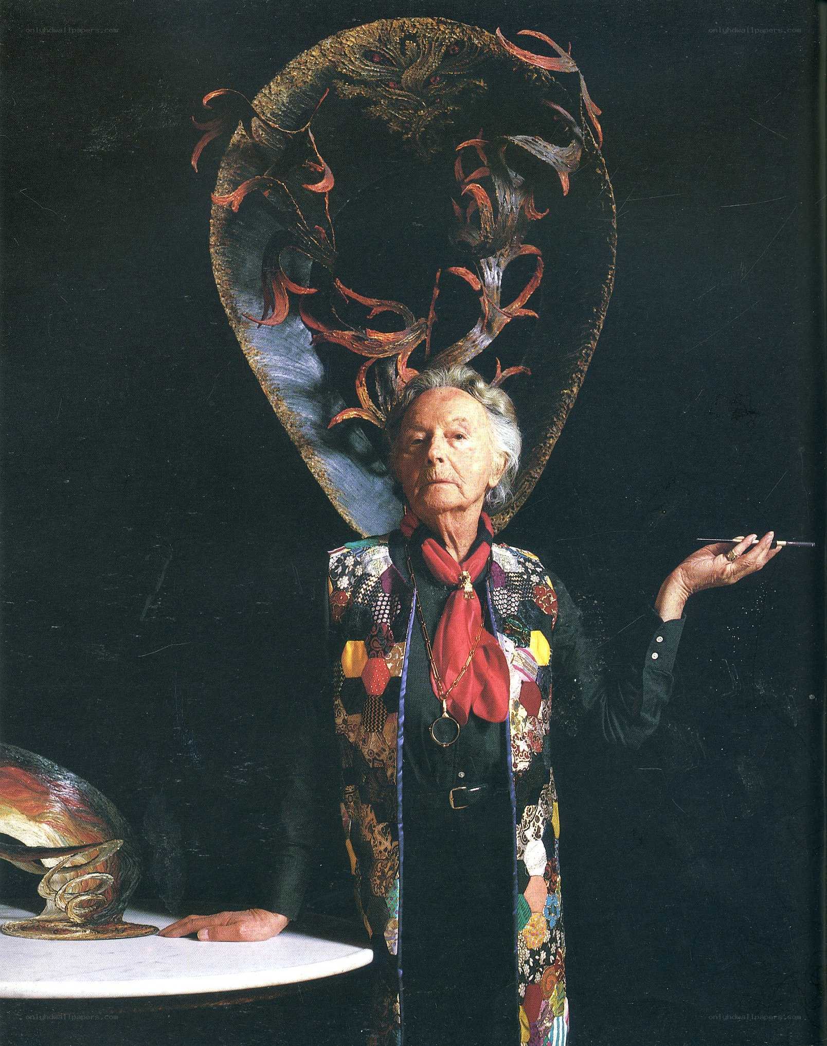 woman with elaborate hat and patchwork coat