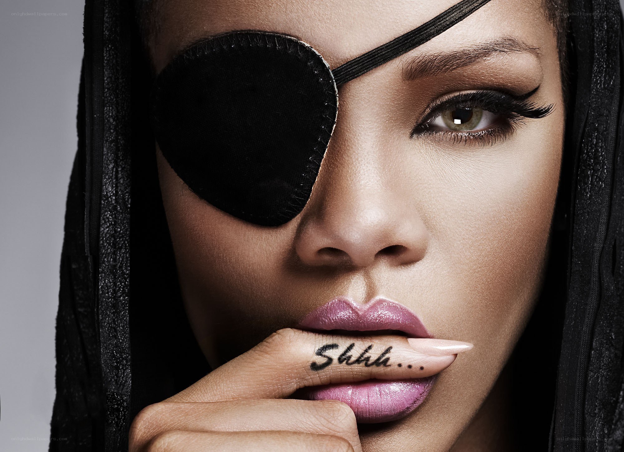 woman with eye patch and finger tattoo